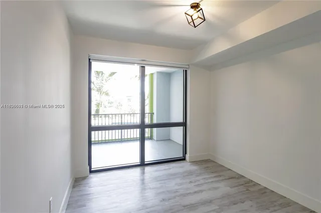 a view of a kitchen with wooden floor and a sink