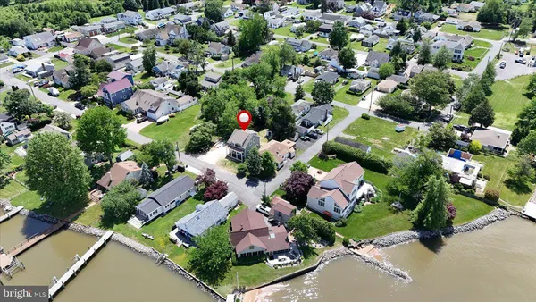 an aerial view of a house with a yard and lake view