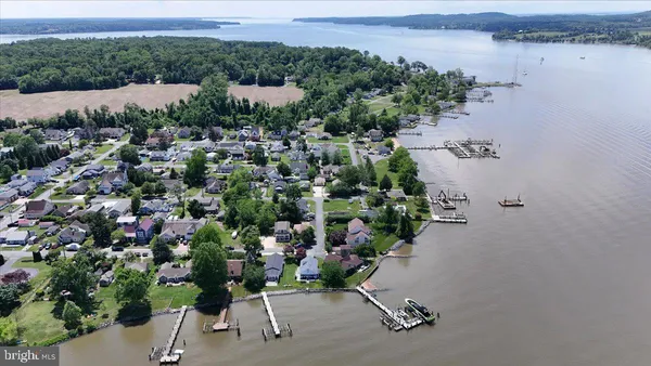 an aerial view of a houses with yard