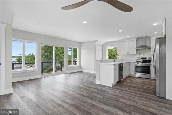 a kitchen with a stove top oven and a refrigerator