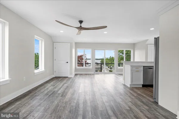 a view of a livingroom with furniture wooden floor and window