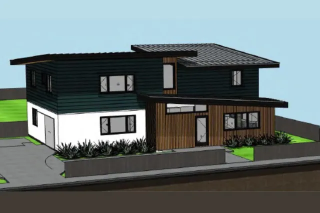 a front view of a house with garage and plants