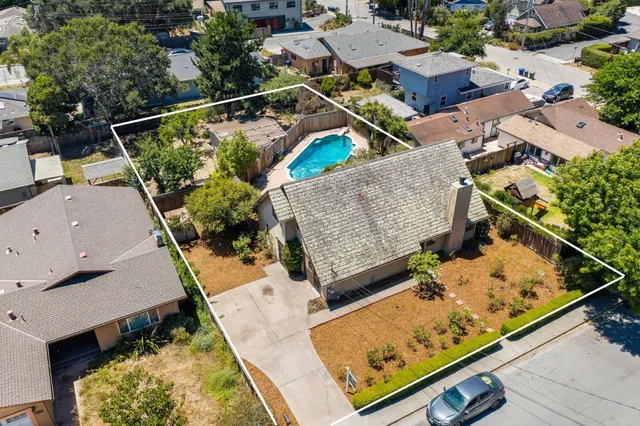 an aerial view of house with a swimming pool