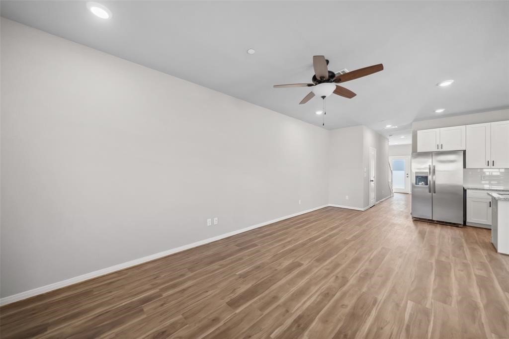 800 North Thompson Street Conroe, TX 77301 - Photo 11 of 25 a view of a kitchen with a sink and wooden floor