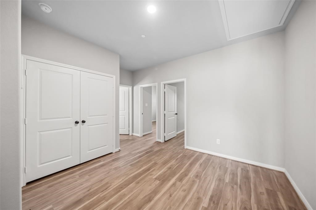 800 North Thompson Street Conroe, TX 77301 - Photo 12 of 25 a view of an empty room and wooden floor