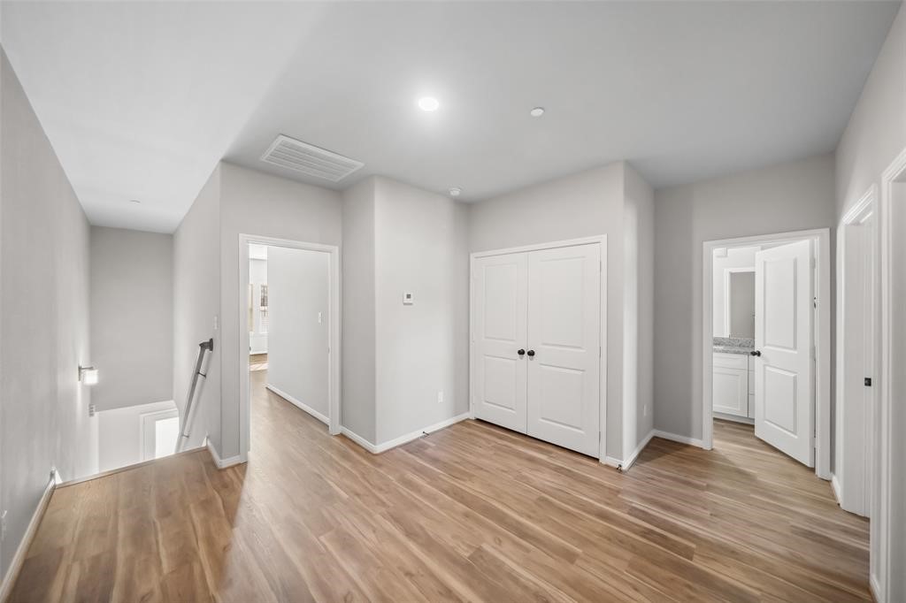 800 North Thompson Street Conroe, TX 77301 - Photo 13 of 25 a view of a room with wooden floor and stairs