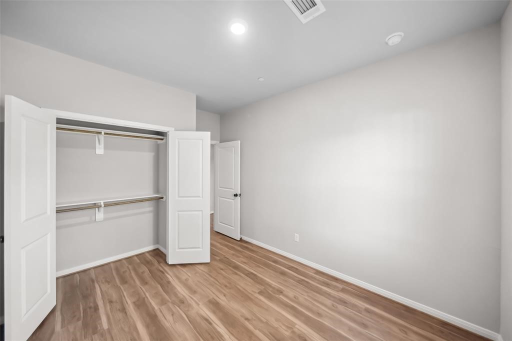 800 North Thompson Street Conroe, TX 77301 - Photo 15 of 25 a view of an empty room with wooden floor