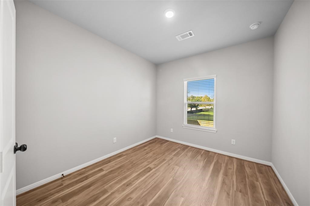 800 North Thompson Street Conroe, TX 77301 - Photo 17 of 25 a view of empty room with wooden floor
