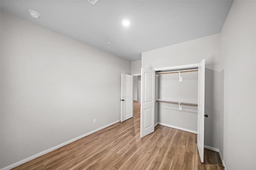 800 North Thompson Street Conroe, TX 77301 - Photo 18 of 25 a view of empty room with wooden floor