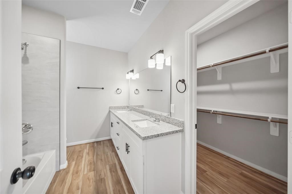 800 North Thompson Street Conroe, TX 77301 - Photo 23 of 25 a bathroom with a sink and a mirror