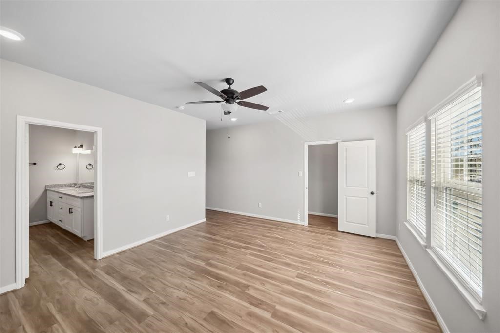 800 North Thompson Street Conroe, TX 77301 - Photo 24 of 25 a view of livingroom with hardwood floor and a ceiling fan