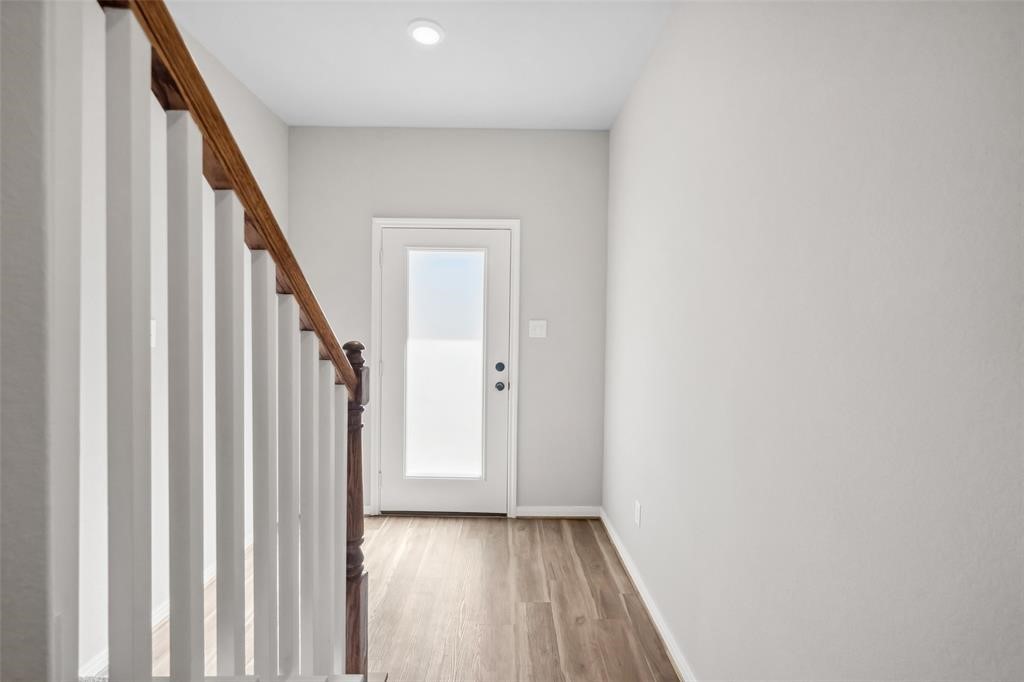 800 North Thompson Street Conroe, TX 77301 - Photo 3 of 25 a view of a hallway with wooden floor and entryway
