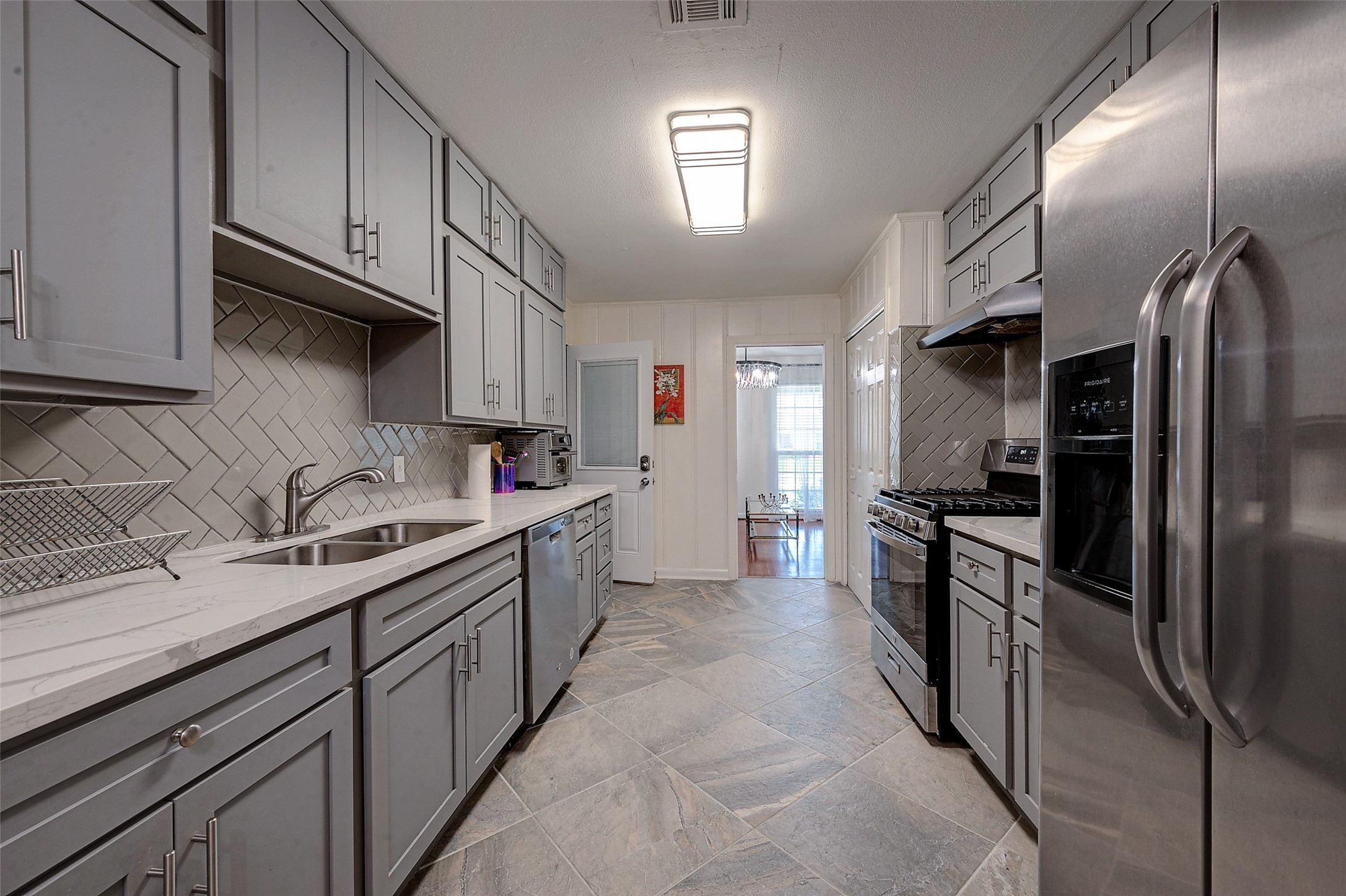 4005 Omeara Drive Houston, TX 77025 - Photo 15 of 49 a kitchen with stainless steel appliances granite countertop a refrigerator a sink a stove and oven