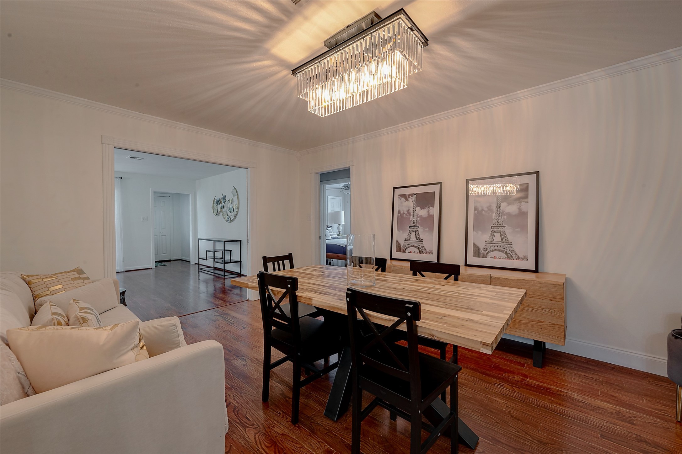 4005 Omeara Drive Houston, TX 77025 - Photo 21 of 49 a living room with furniture a chandelier and wooden floor