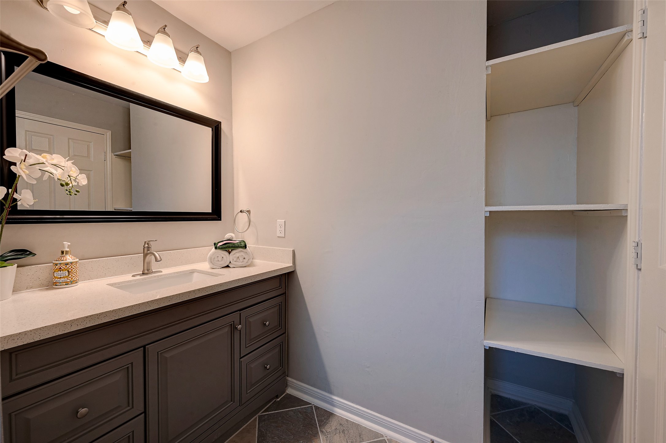 4005 Omeara Drive Houston, TX 77025 - Photo 27 of 49 a bathroom with a double vanity sink and mirror