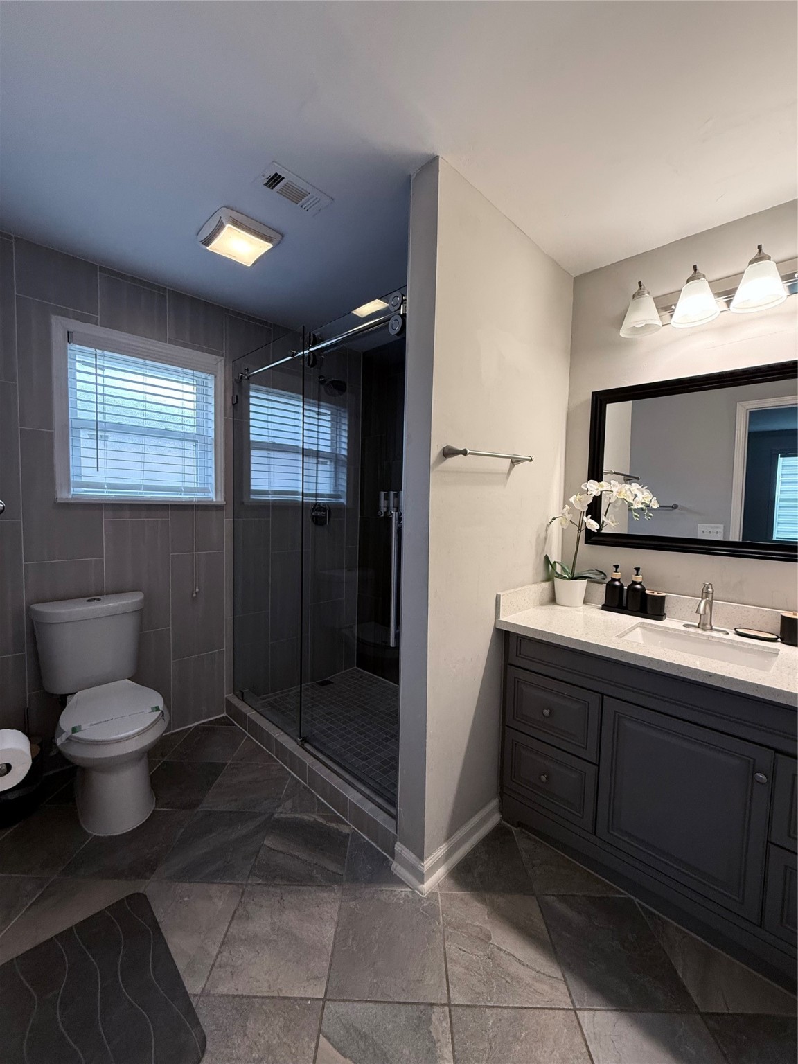 4005 Omeara Drive Houston, TX 77025 - Photo 28 of 49 a bathroom with a toilet sink and mirror