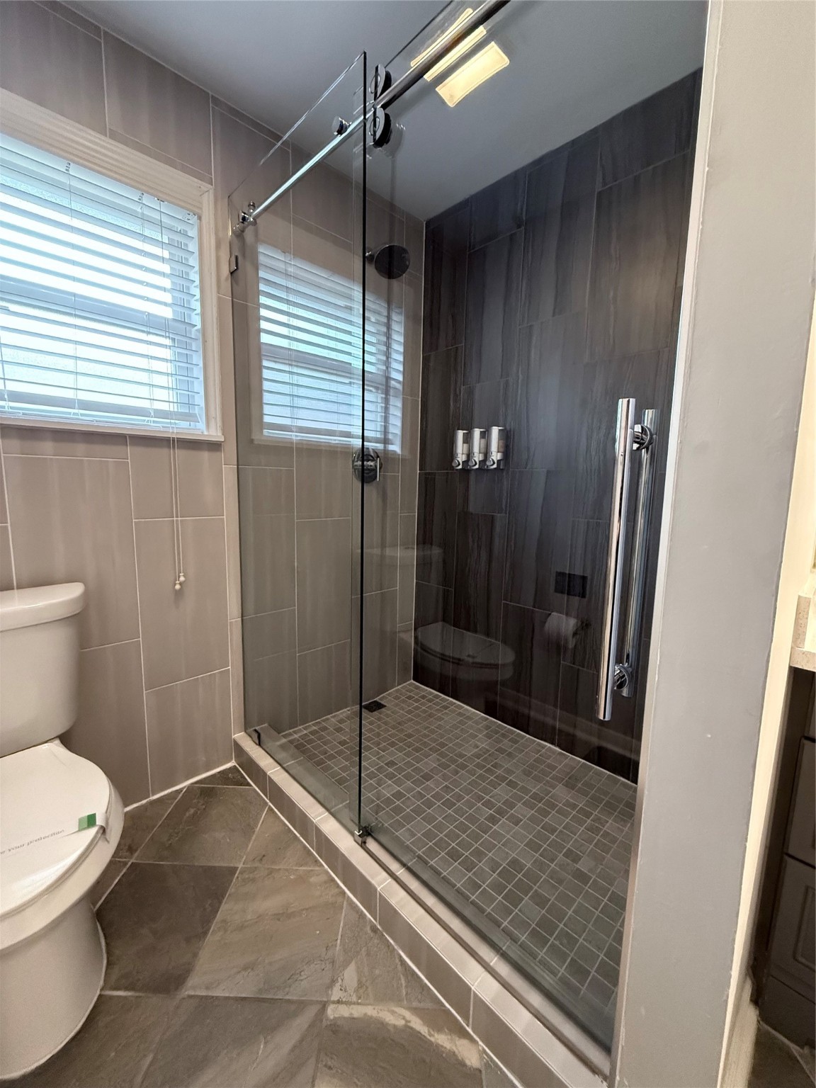 4005 Omeara Drive Houston, TX 77025 - Photo 29 of 49 a bathroom with a shower and a toilet