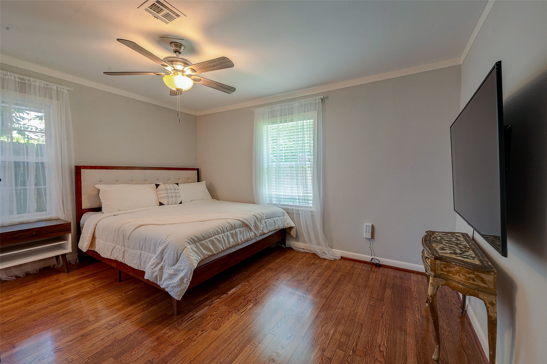 4005 Omeara Drive Houston, TX 77025 - Photo 41 of 49 a bedroom with a bed and a flat tv screen on dresser