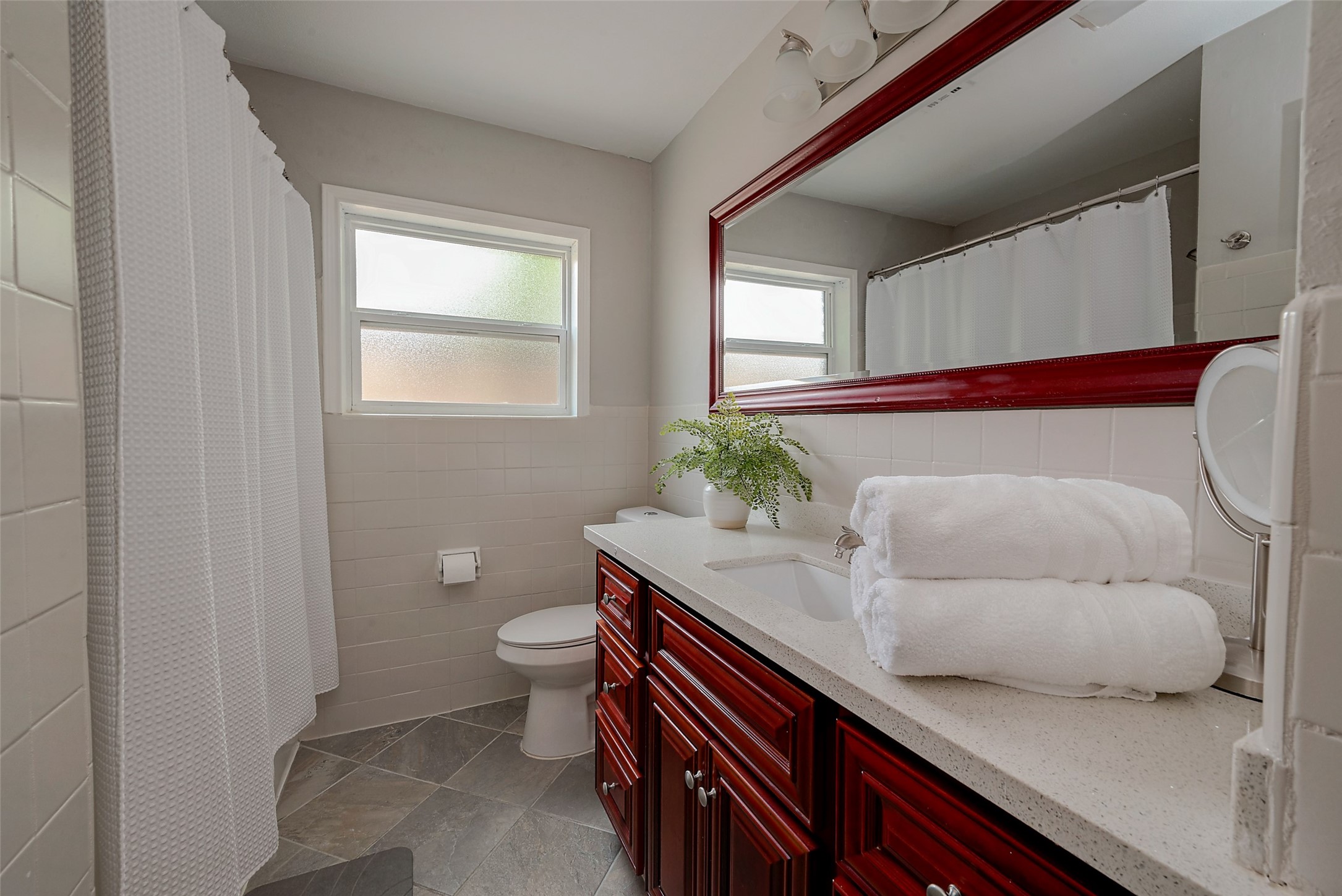 4005 Omeara Drive Houston, TX 77025 - Photo 42 of 49 a bathroom with a granite countertop sink and a toilet
