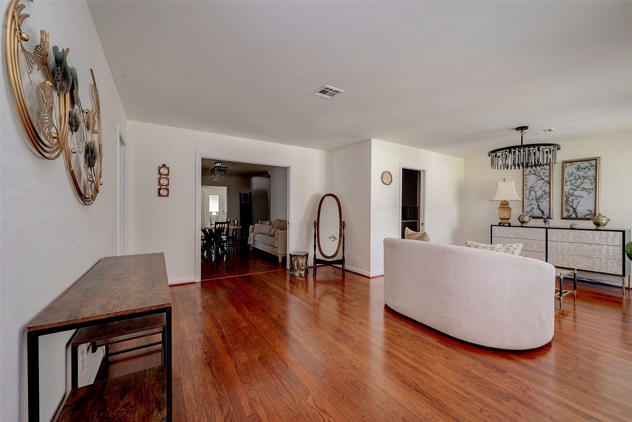 4005 Omeara Drive Houston, TX 77025 - Photo 5 of 49 a living room with furniture a dining table and wooden floor
