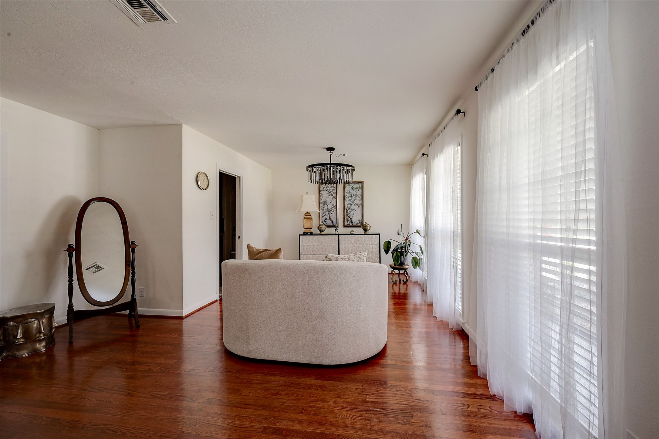 4005 Omeara Drive Houston, TX 77025 - Photo 6 of 49 a living room with furniture a table and wooden floor