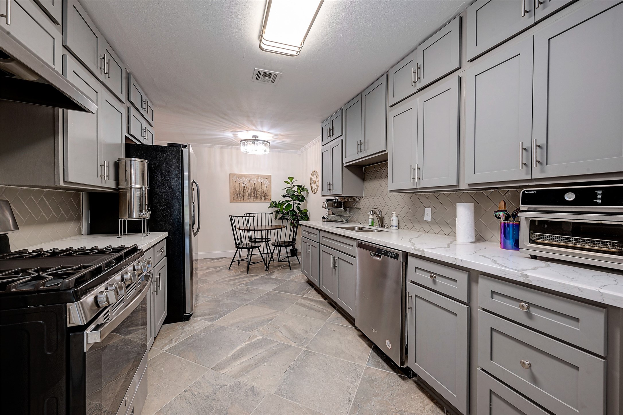 4005 Omeara Drive Houston, TX 77025 - Photo 10 of 49 a kitchen with stainless steel appliances granite countertop a stove refrigerator sink and cabinets