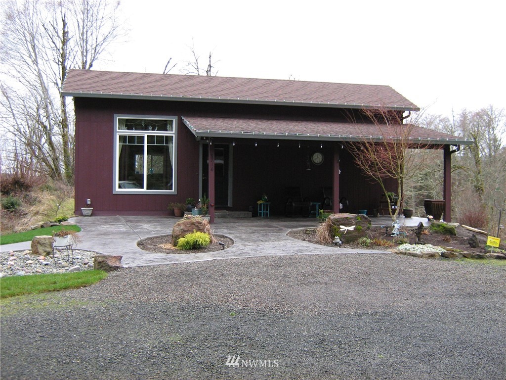 8710 Northeast Quarry Road La Center, WA 98629 - Photo 1 of 1 a view of a house with backyard and porch