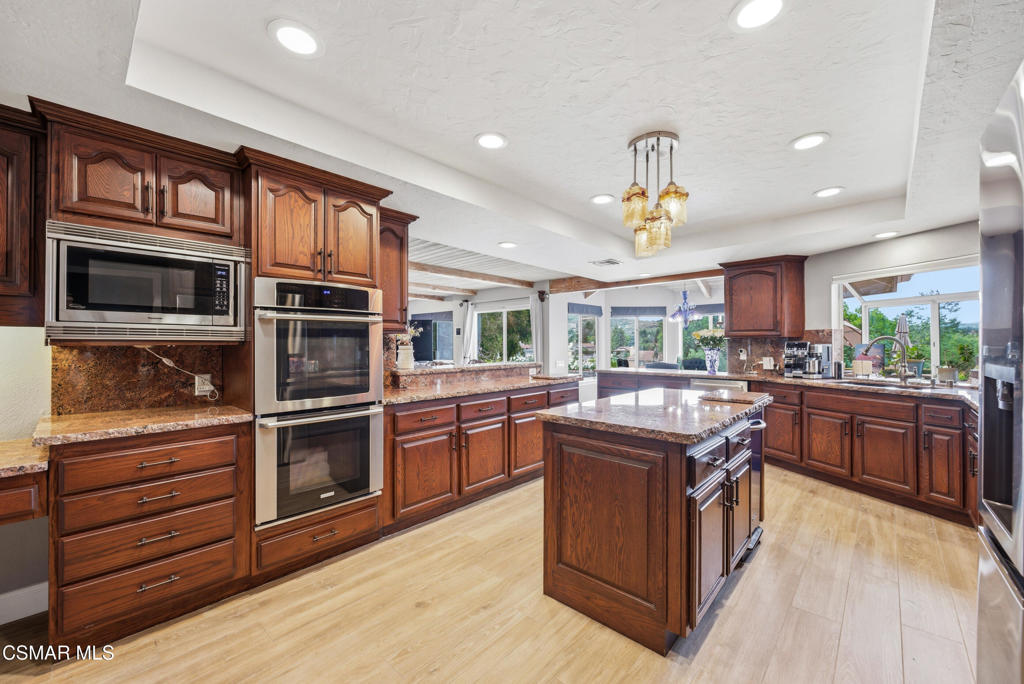 206 Rangely Court Simi Valley, CA 93065 - Photo 11 of 63 a kitchen with stainless steel appliances granite countertop a stove and a sink