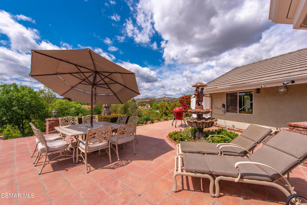 206 Rangely Court Simi Valley, CA 93065 - Photo 39 of 63 a view of a patio with a table and chairs under an umbrella