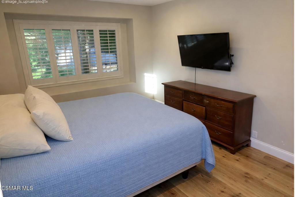 206 Rangely Court Simi Valley, CA 93065 - Photo 54 of 63 a bedroom with a bed and a flat screen tv