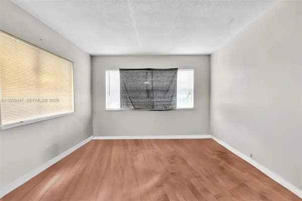 a view of a room with wooden floor