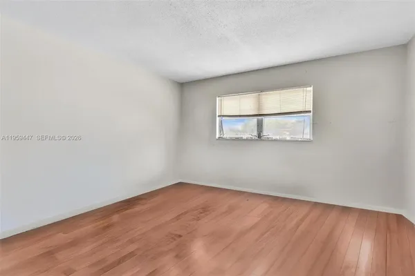 a view of a room with wooden floor