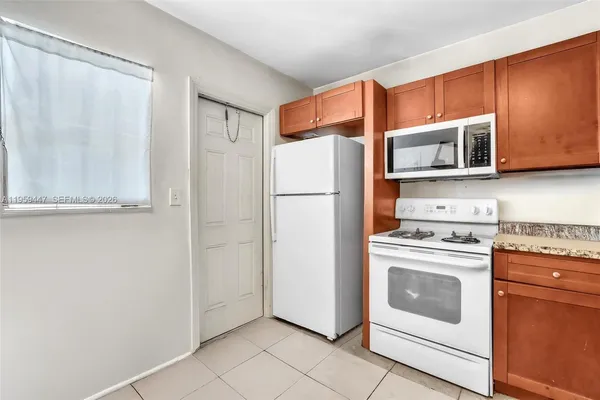 a kitchen with stainless steel appliances white cabinets and a refrigerator