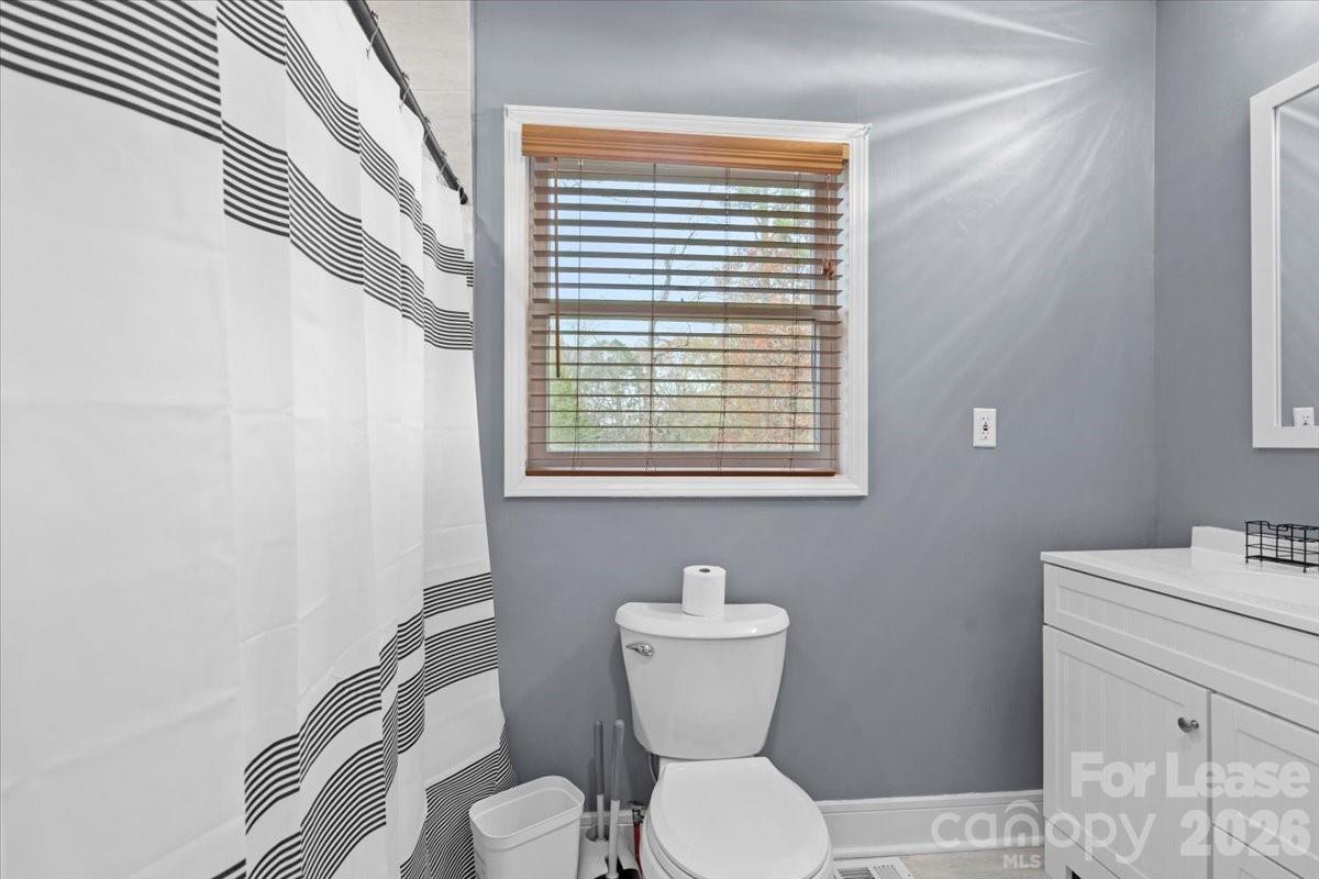 2708 Mooresville Road, Unit B Salisbury, NC 28147 - Photo 8 of 11 a bathroom with a toilet a sink and a window