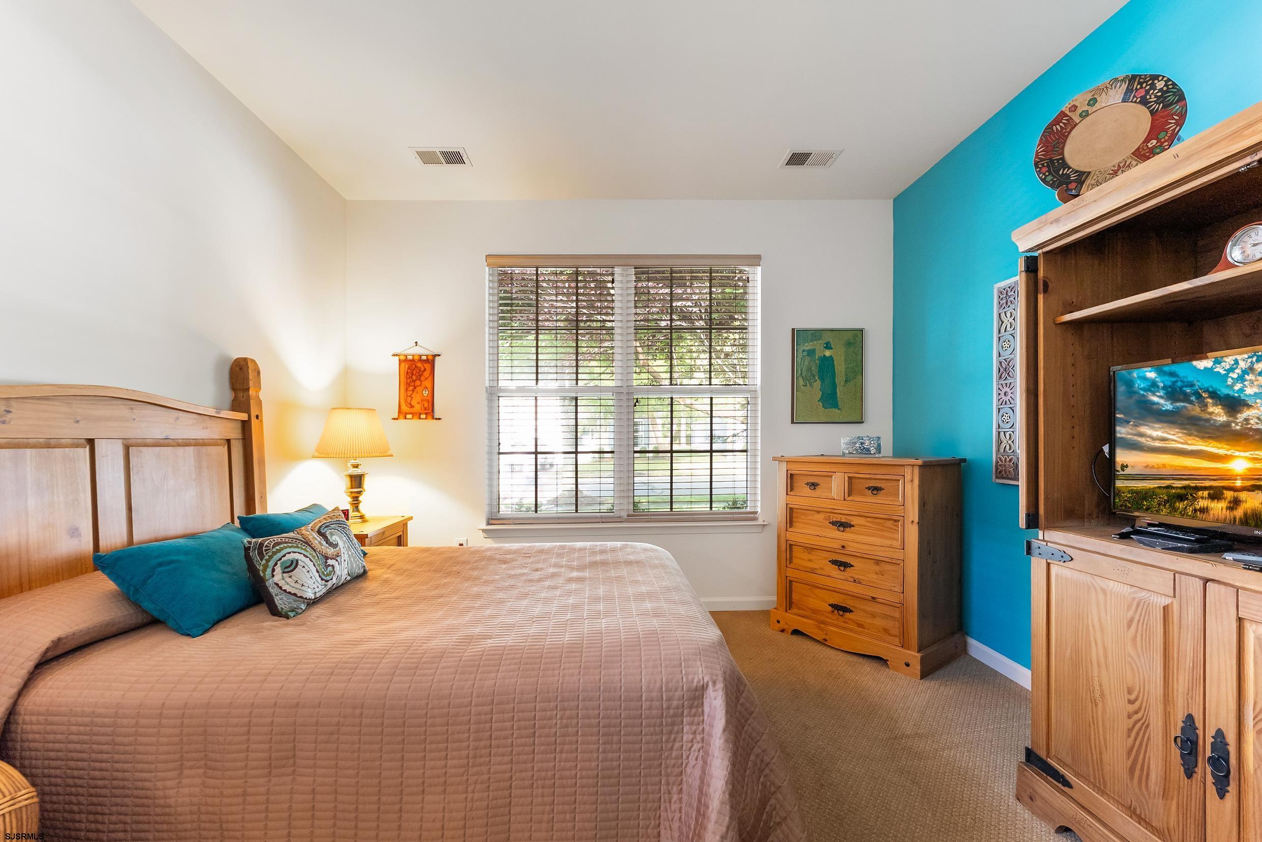 4 Northampton Road Smithville, NJ 08205 - Photo 27 of 39 a bedroom with a bed and flat screen tv