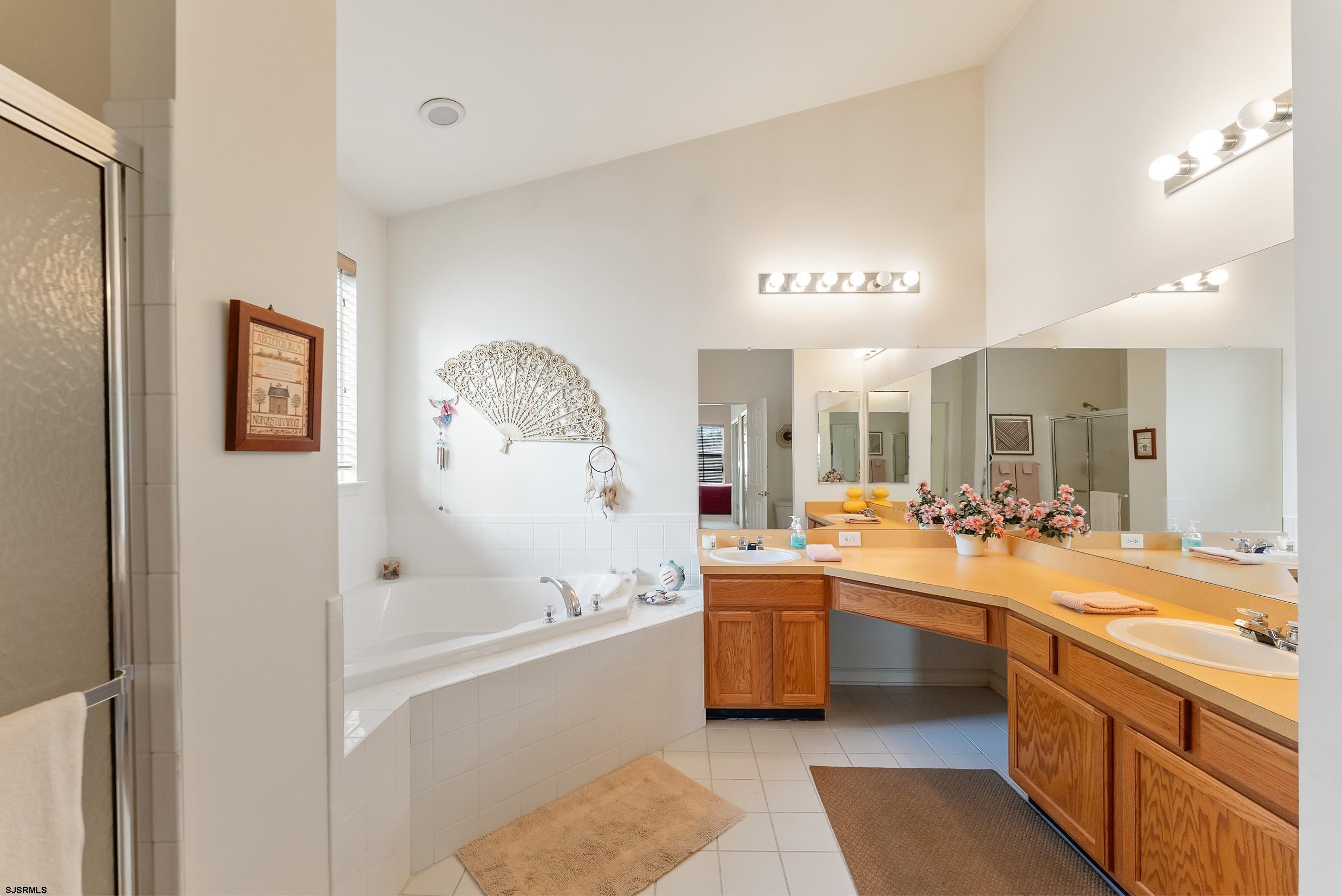4 Northampton Road Smithville, NJ 08205 - Photo 34 of 39 a large white bathroom with a large tub and sink
