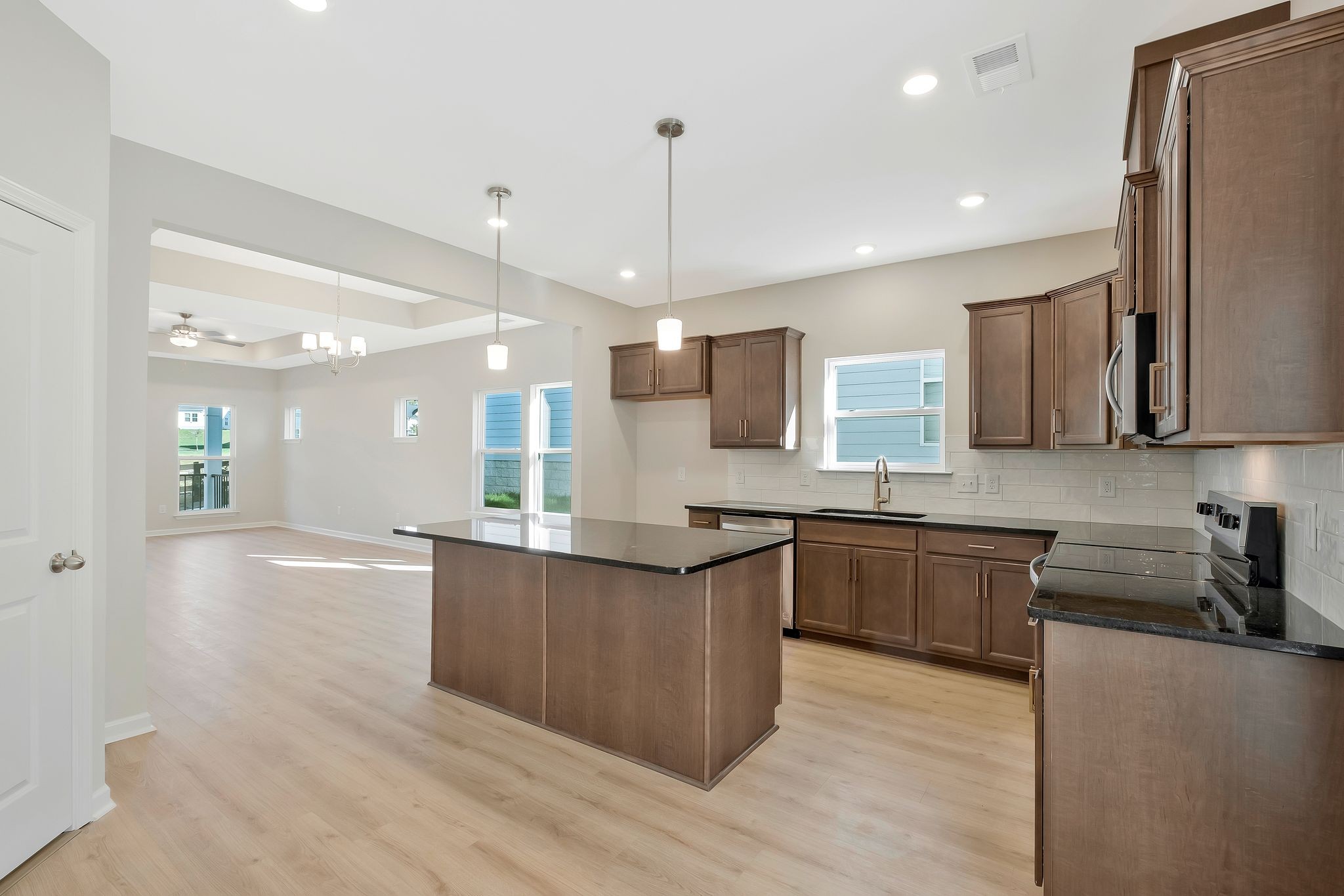 7321 Carothers Road Nolensville, TN 37135 - Photo 11 of 32 a kitchen with stainless steel appliances granite countertop wooden cabinets a stove a sink and a refrigerator