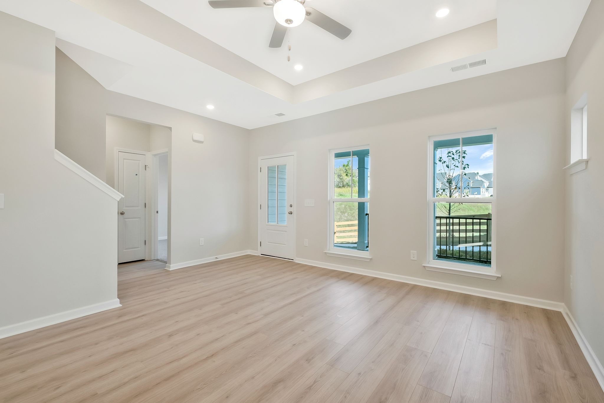 7321 Carothers Road Nolensville, TN 37135 - Photo 8 of 32 an empty room with wooden floor chandelier fan and windows
