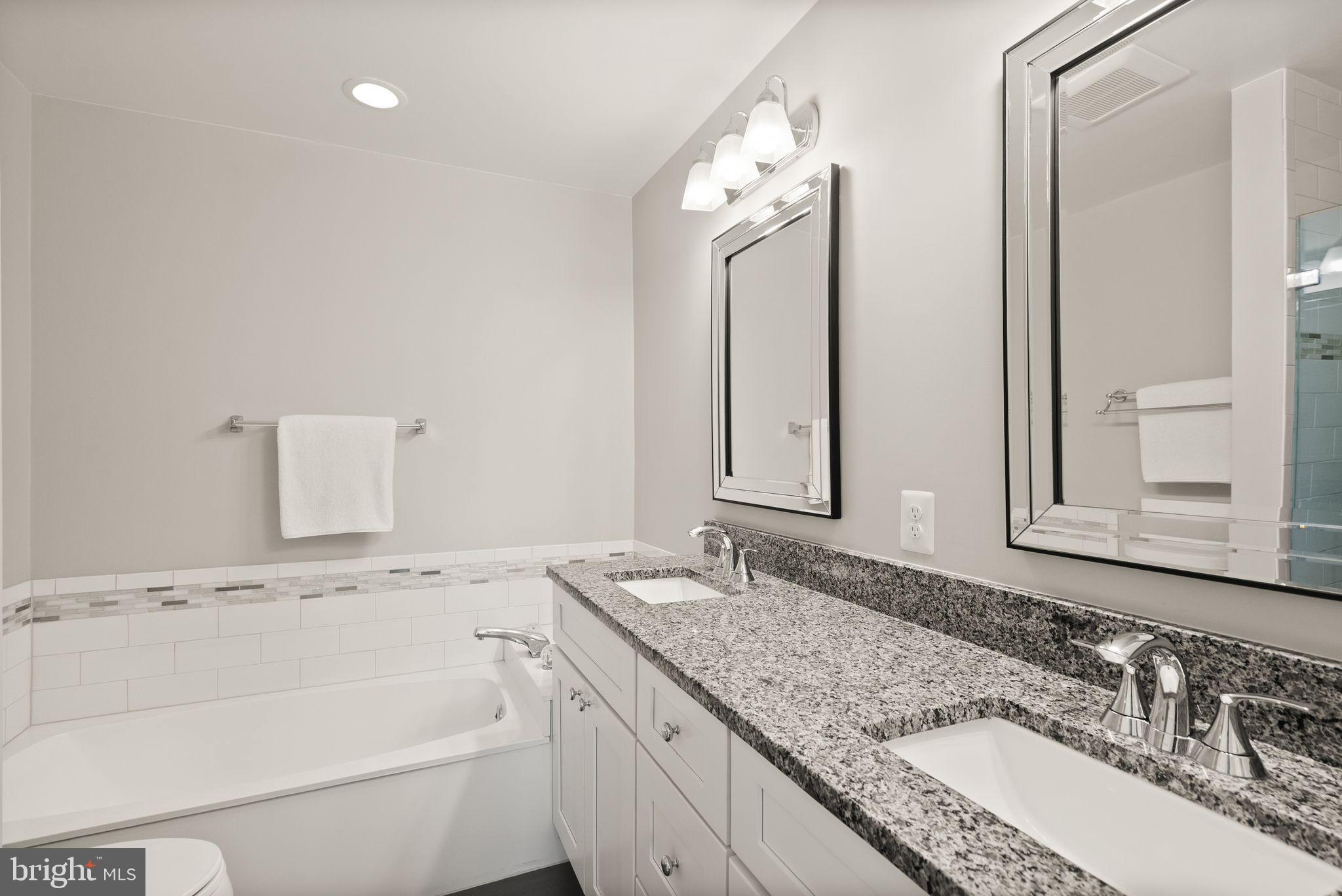 6369 English Ivy Way Springfield, VA 22152 - Photo 35 of 62 a bathroom with a granite countertop sink and a mirror