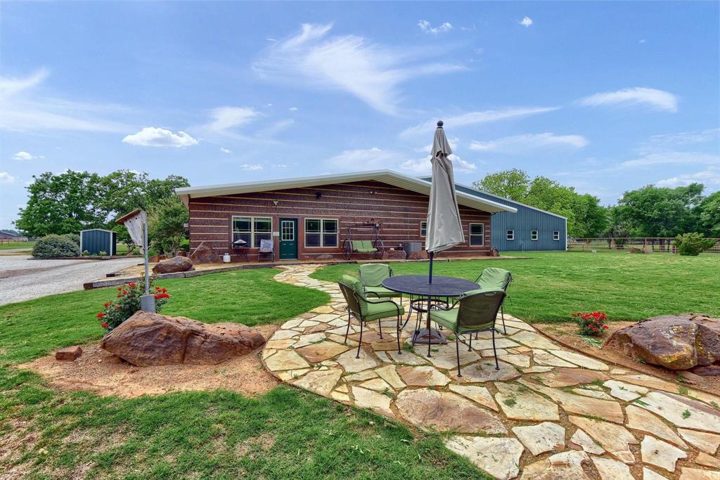 10898 Friendship Road Pilot Point, TX 76258 - Photo 8 of 24 Back of property featuring a lawn and a patio area