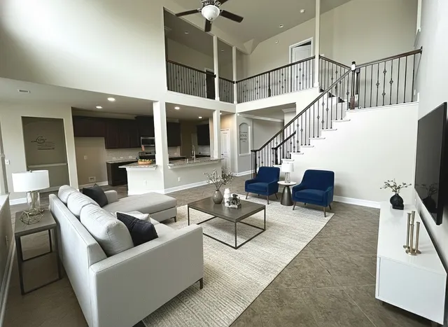 a living room with furniture and a flat screen tv