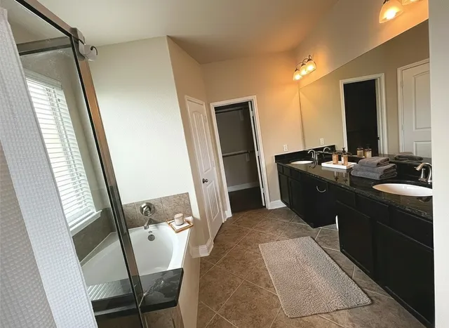 a bathroom with a double vanity sink and a mirror