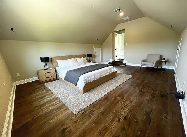 a spacious bedroom with a bed and window