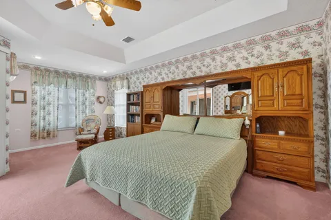 a bathroom with a granite countertop sink a toilet a mirror and bathtub