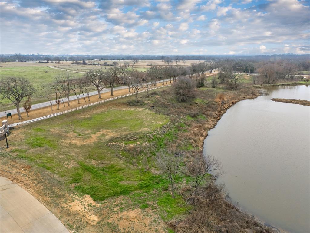 1021 Willow Point Oak Point, TX 75068 - Photo 17 of 22 a view of a lake with a yard and mountain in the back