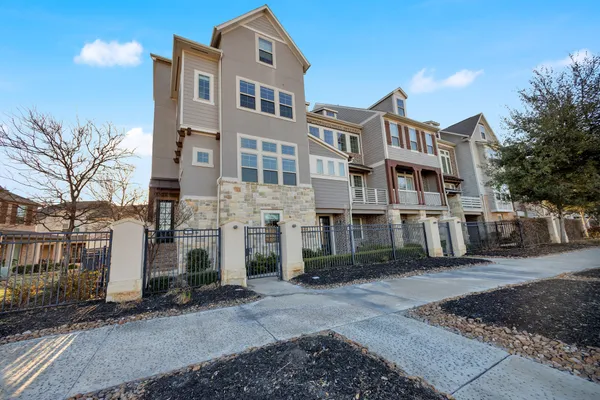 a city street lined with buildings and a yard