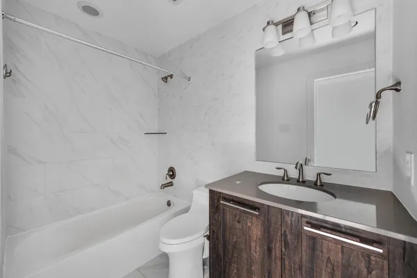 a bathroom with a sink a toilet and bathtub