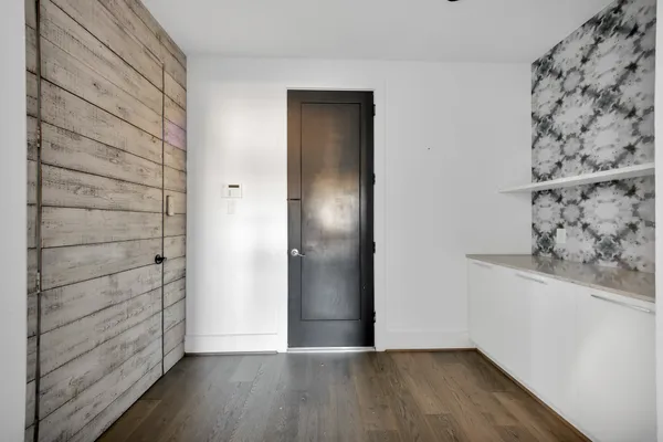 a view of a hallway with wooden floor
