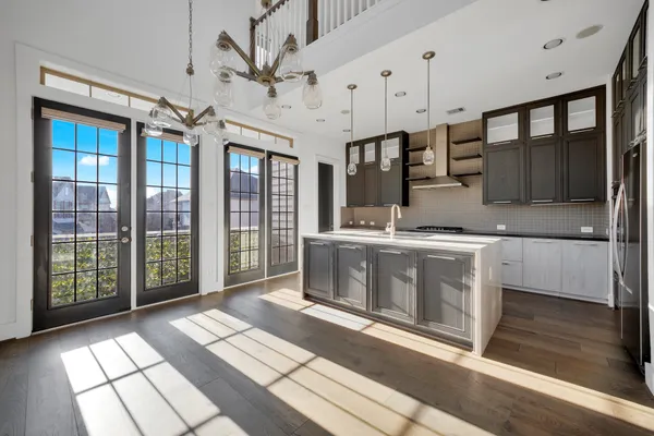 a view of a kitchen with stainless steel appliances granite countertop a stove a sink and a granite counter top