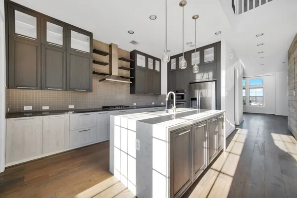 a kitchen with stainless steel appliances granite countertop a sink stove and wooden cabinets
